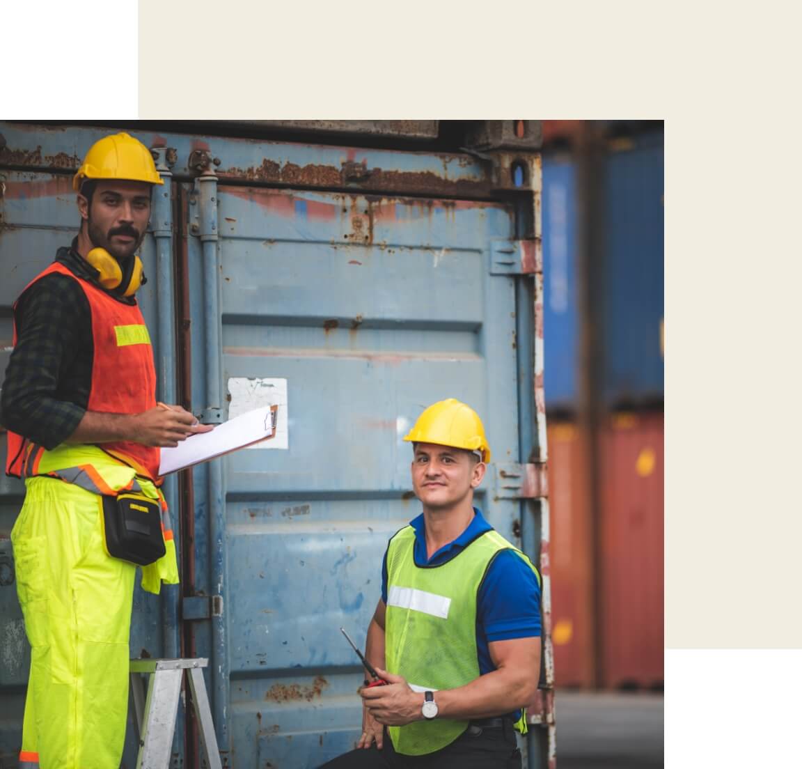 Two men checking a shipping container